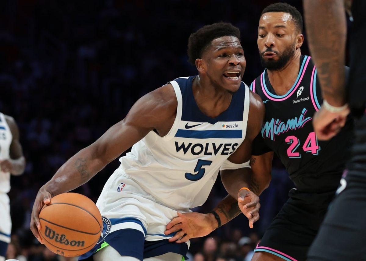 Jan 3, 2026; Miami, Florida, USA; Minnesota Timberwolves guard Anthony Edwards (5) drives to the basket against Miami Heat guard Norman Powell (24) during the first quarter at Kaseya Center. Mandatory Credit: Sam Navarro-Imagn Images