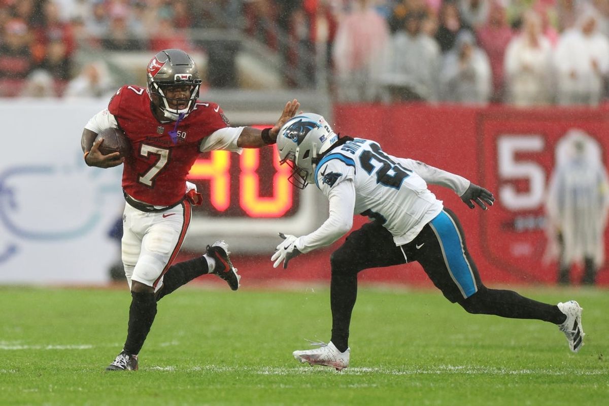 Jan 3, 2026; Tampa, Florida, USA; Tampa Bay Buccaneers running back Bucky Irving (7) runs against Carolina Panthers cornerback Chau Smith-Wade (26) in the first half at Raymond James Stadium. Mandatory Credit: Nathan Ray Seebeck-Imagn Images