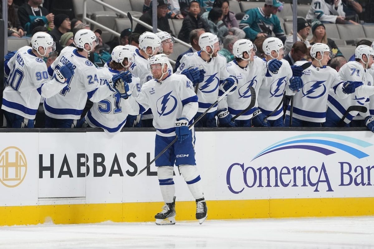Jan 3, 2026; San Jose, California, USA; Tampa Bay Lightning defenseman Darren Raddysh (43) is congratulated by teammates after scoring a goal against the San Jose Sharks during the second period at SAP Center at San Jose. Mandatory Credit: Darren Yamashita-Imagn Images