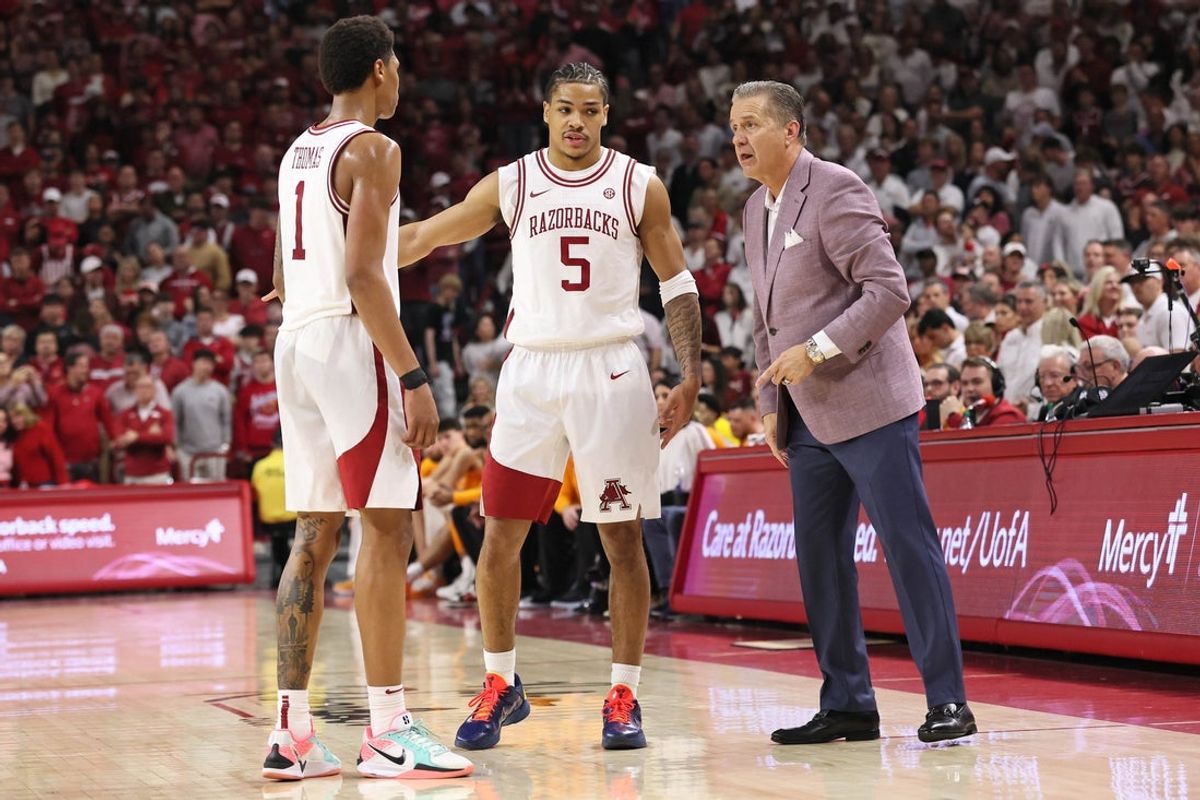 Jan 3, 2026; Fayetteville, Arkansas, USA; Arkansas Razorbacks guards Meleek Thomas (1) and Darius Acuff Jr (5) talk to head coach John Calipari during the second half against the Tennessee Volunteers at Bud Walton Arena.  Mandatory Credit: Nelson Chenault-Imagn Images