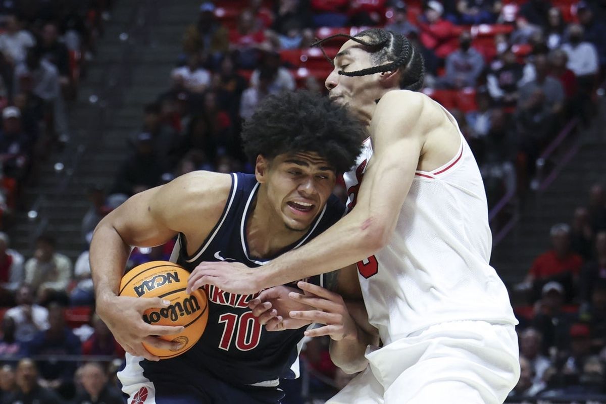 Jan 3, 2026; Salt Lake City, Utah, USA; Arizona Wildcats forward Koa Peat (10) drives against Utah Utes forward Keanu Dawes (8) during the first half at Jon M. Huntsman Center. Mandatory Credit: Rob Gray-Imagn Images