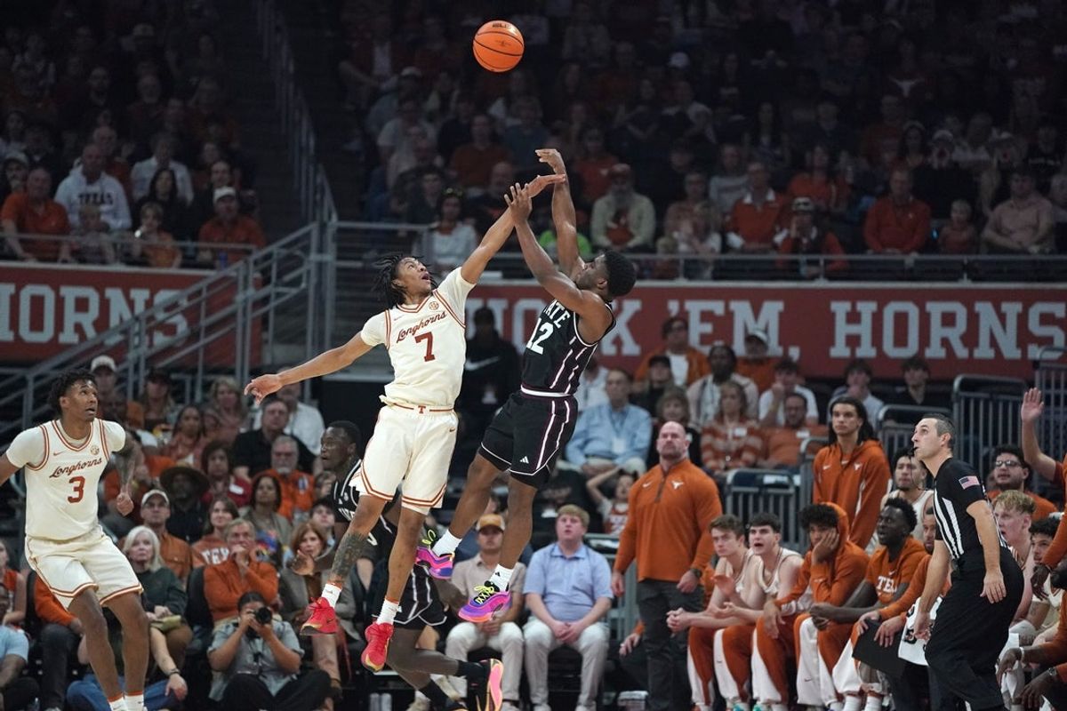 Jan 3, 2026; Austin, Texas, USA; Mississippi State Bulldogs guard Josh Hubbard (12) shoots a three-point basket against Texas Longhorns guard Simeon Wilcher (7) during the first half at Moody Center. Mandatory Credit: Dustin Safranek-Imagn Images