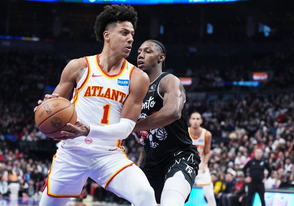 Jan 3, 2026; Toronto, Ontario, CAN; Atlanta Hawks forward Jalen Johnson (1) controls the ball as Toronto Raptors forward RJ Barrett (9) tries to defend during the first quarter at Scotiabank Arena. Mandatory Credit: Nick Turchiaro-Imagn Images