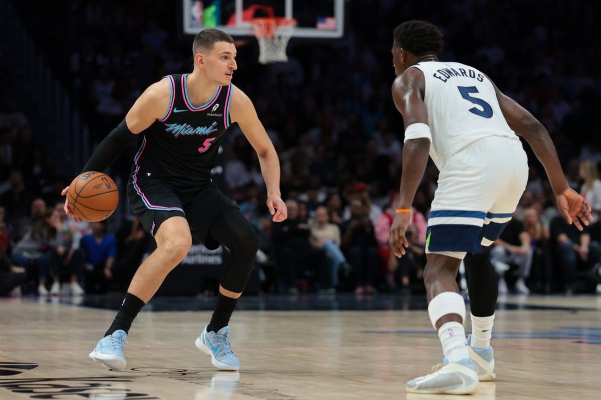 Jan 3, 2026; Miami, Florida, USA; Miami Heat forward Nikola Jovic (5) dribbles the basketball as Minnesota Timberwolves guard Anthony Edwards (5) defends during the third quarter at Kaseya Center. Mandatory Credit: Sam Navarro-Imagn Images