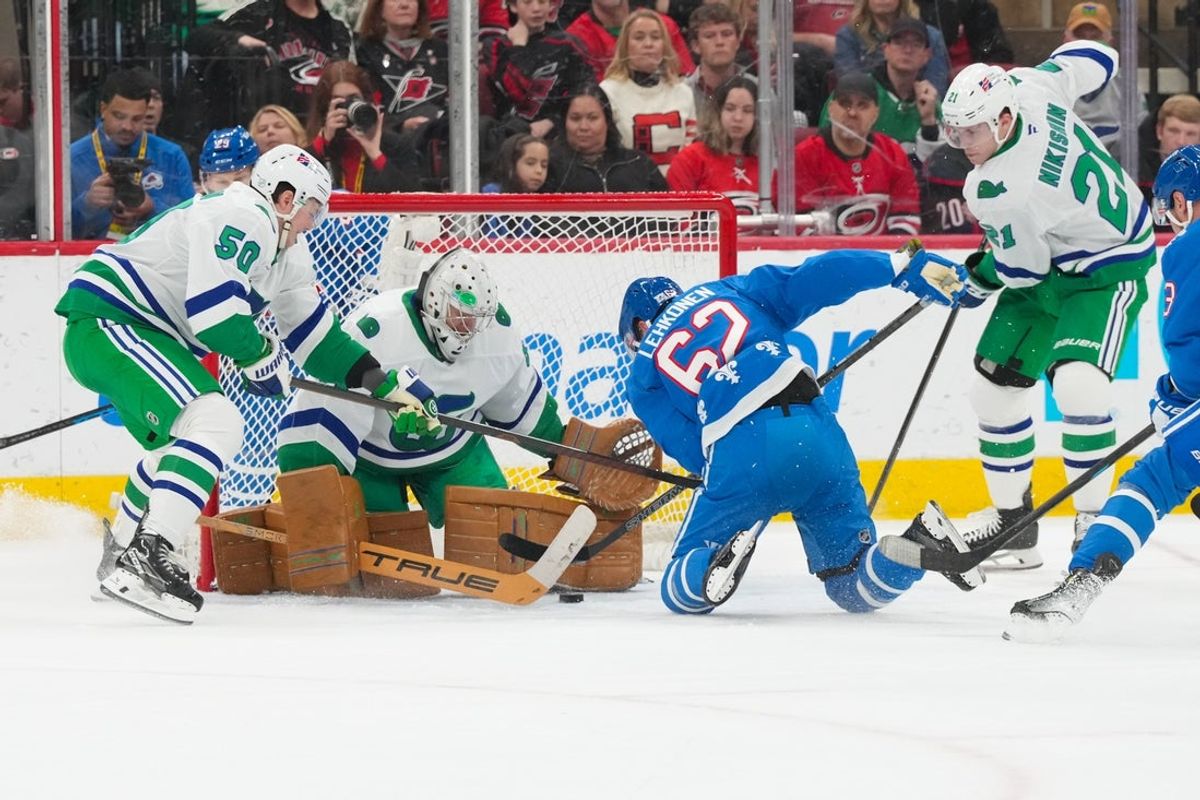 Jan 3, 2026; Raleigh, North Carolina, USA; Carolina Hurricanes goaltender Frederik Andersen (31) stops the shot by Colorado Avalanche left wing Artturi Lehkonen (62) during the first period at Lenovo Center. Mandatory Credit: James Guillory-Imagn Images