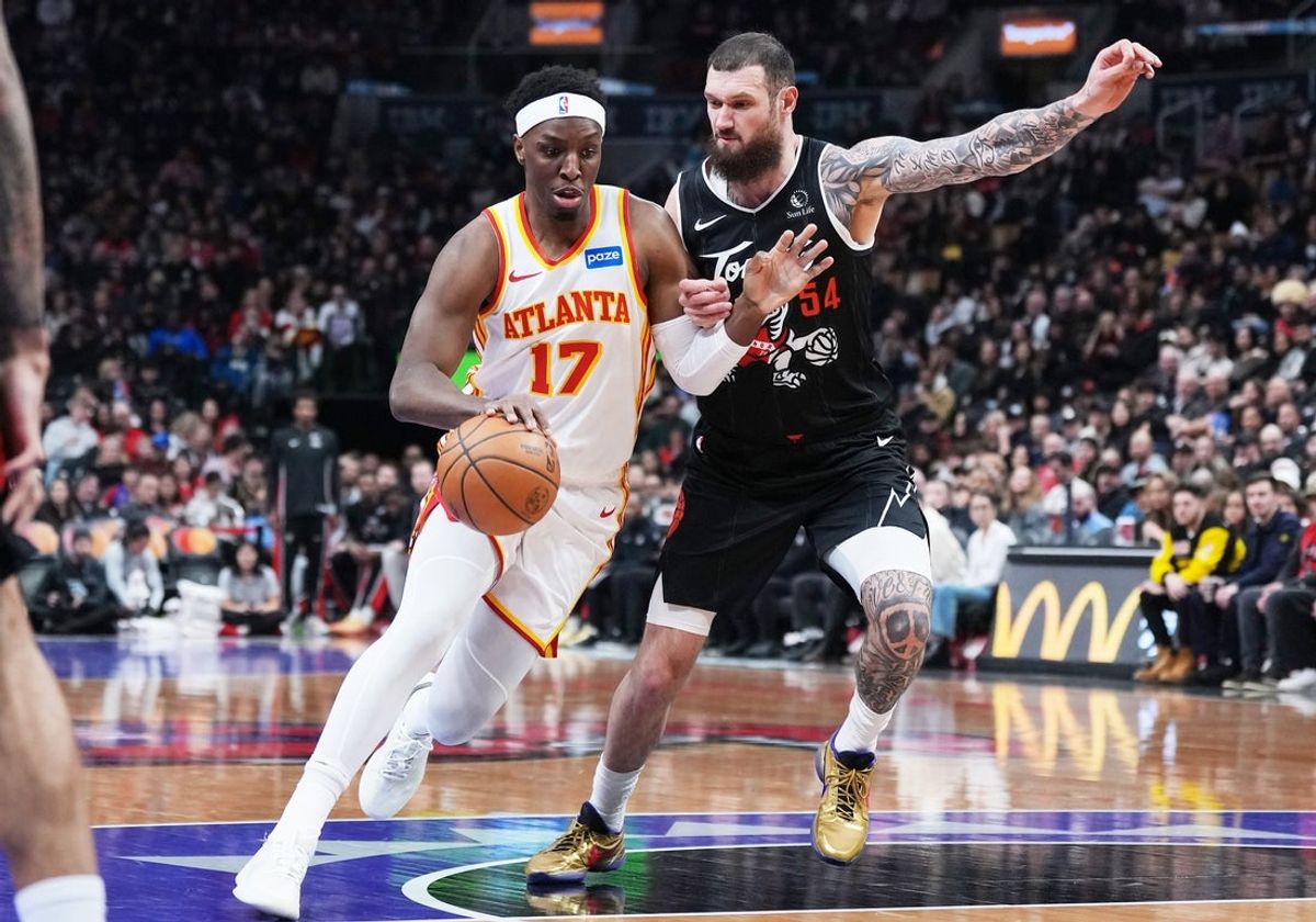 Jan 3, 2026; Toronto, Ontario, CAN; Atlanta Hawks forward Onyeka Okongwu (17) controls the ball as Toronto Raptors forward Sandro Mamukelashvili (54) tries to defend during the first quarter at Scotiabank Arena. Mandatory Credit: Nick Turchiaro-Imagn Images