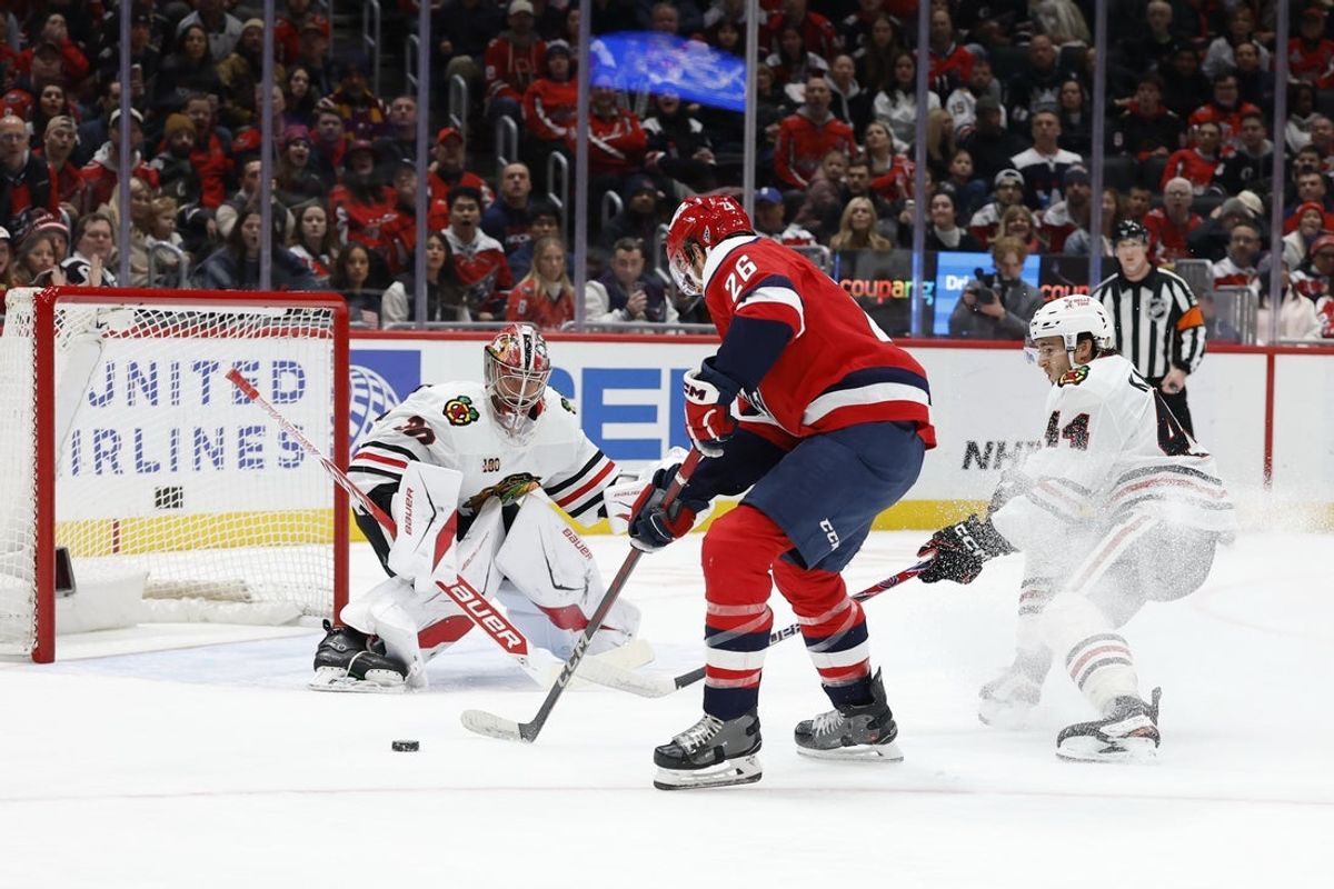 Jan 3, 2026; Washington, District of Columbia, USA; Chicago Blackhawks goaltender Spencer Knight (30) prepares to make a save on Washington Capitals center Nic Dowd (26) during the first period at Capital One Arena. Mandatory Credit: Geoff Burke-Imagn Images