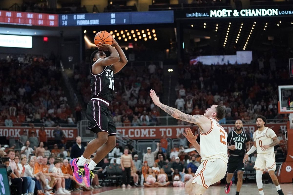 Jan 3, 2026; Austin, Texas, USA; Mississippi State Bulldogs guard Josh Hubbard (12) shoots a three point basket against Texas Longhorns guard Chendall Weaver (2) during the second half at Moody Center. Mandatory Credit: Dustin Safranek-Imagn Images