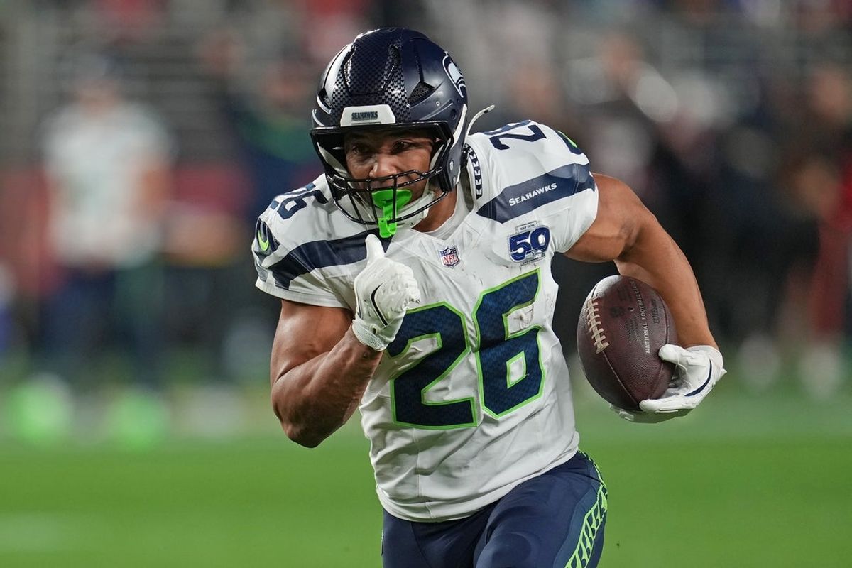 Jan 3, 2026; Santa Clara, California, USA; Seattle Seahawks running back Zach Charbonnet (26) rushes the ball against the San Francisco 49ers during the first half at Levi's Stadium. Mandatory Credit: Neville E. Guard-Imagn Images