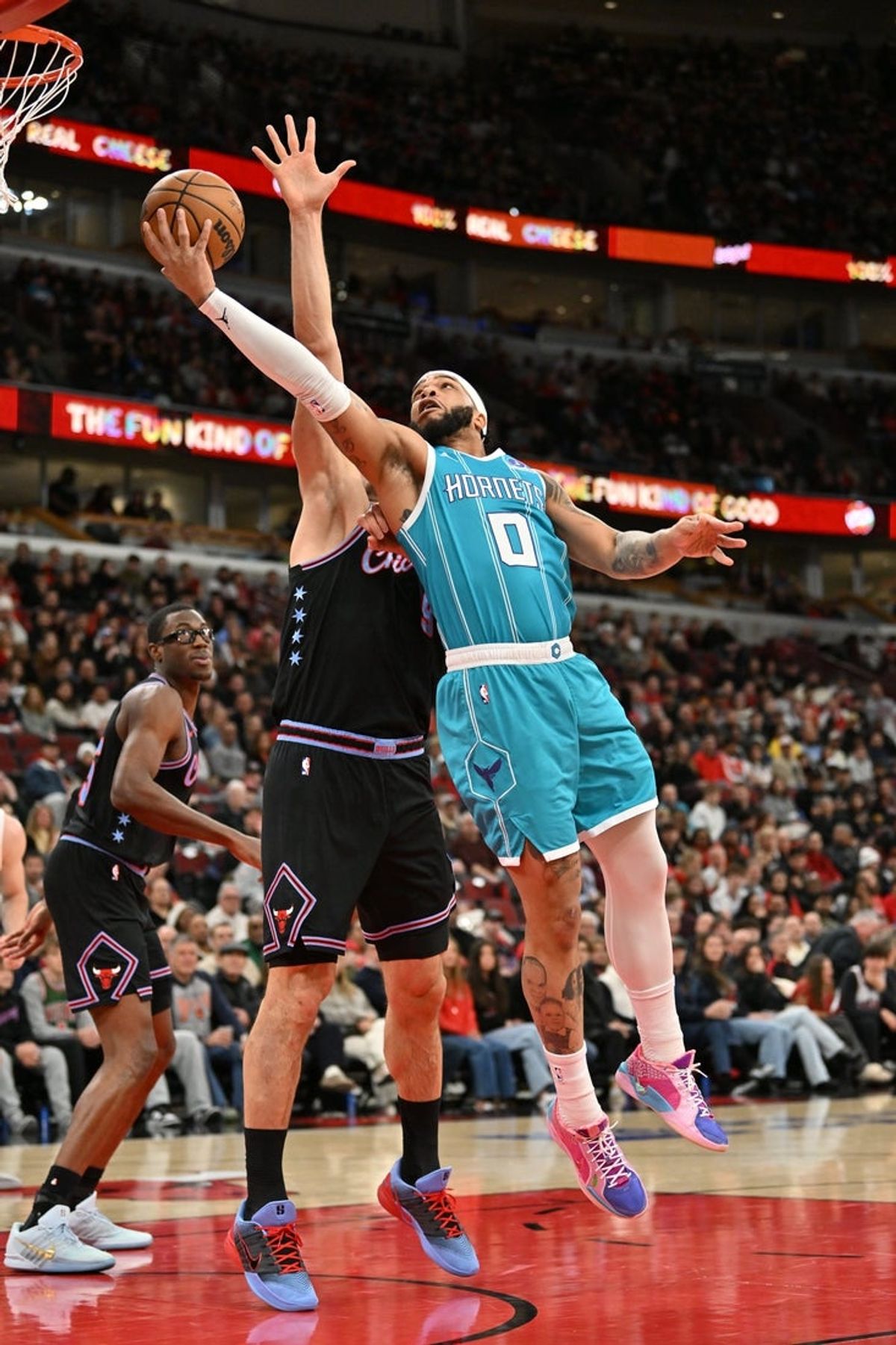 Jan 3, 2026; Chicago, Illinois, USA; Charlotte Hornets forward Miles Bridges (0) goes up for a shot against Chicago Bulls center Nikola Vucevic (9) during the first half at United Center. Mandatory Credit: Patrick Gorski-Imagn Images