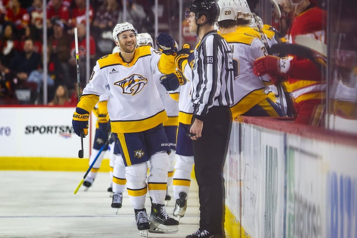 Jan 3, 2026; Calgary, Alberta, CAN; Nashville Predators left wing Michael Bunting (58) celebrates his goal with teammates against the Calgary Flames during the second period at Scotiabank Saddledome. Mandatory Credit: Sergei Belski-Imagn Images