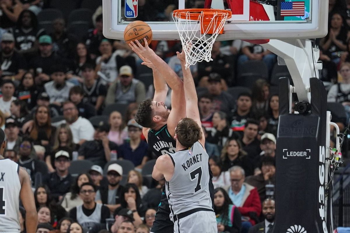 Jan 3, 2026; San Antonio, Texas, USA;  Portland Trail Blazers center Donovan Clingan (23) shoots in front of San Antonio Spurs center/forward Luke Kornet (7) in the first half at Frost Bank Center. Mandatory Credit: Daniel Dunn-Imagn Images