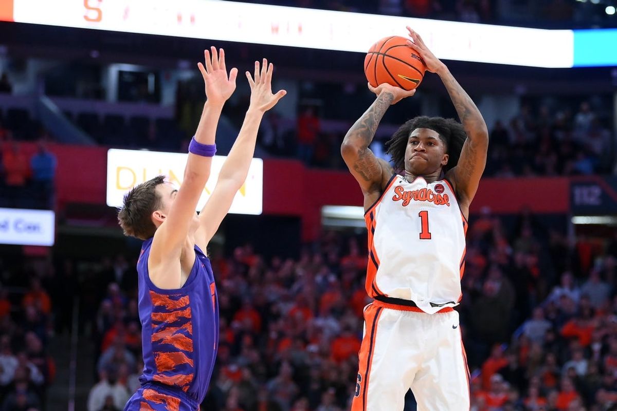 Dec 31, 2025; Syracuse, New York, USA; Syracuse Orange forward Donnie Freeman (1) shoots against Clemson Tigers forward Jake Wahlin (left) during the second half at the JMA Wireless Dome. Mandatory Credit: Rich Barnes-Imagn Images