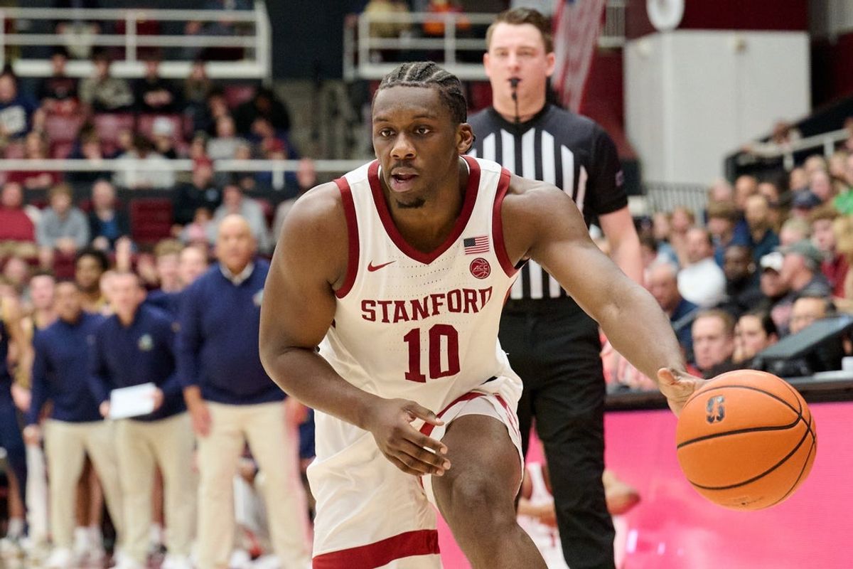 Dec 30, 2025; Stanford, California, USA; Stanford Cardinal forward Chisom Okpara (10) passes the ball and referee Chase Shaw watches the play against the Notre Dame Fighting Irish during the second half at Maples Pavilion. Mandatory Credit: Robert Edwards-Imagn Images