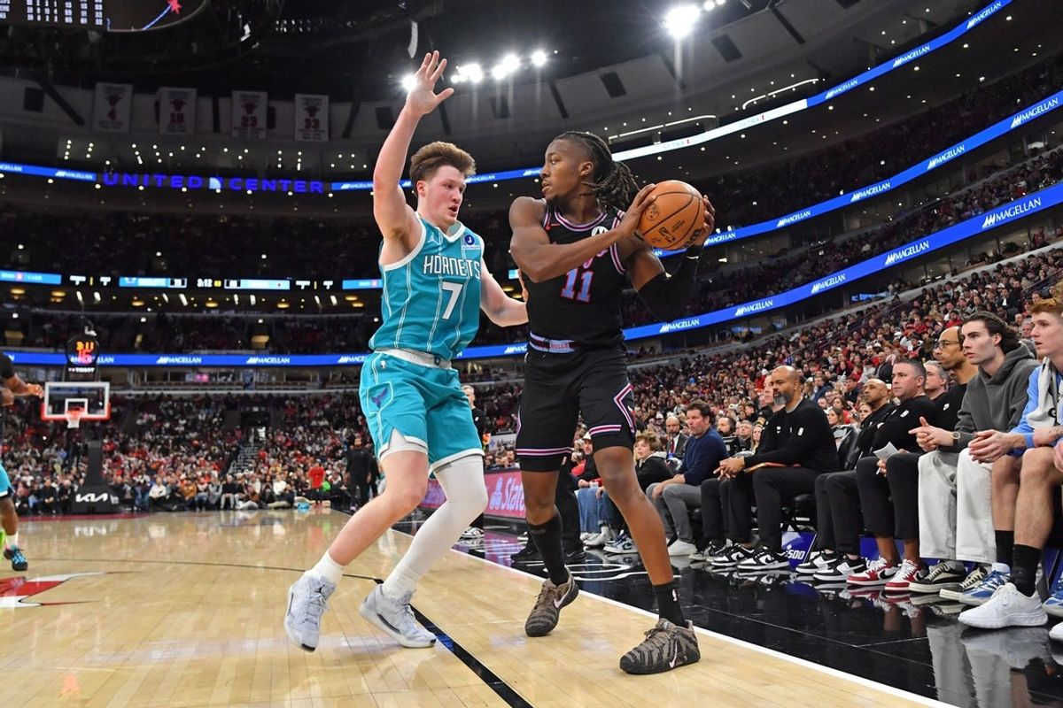 Jan 3, 2026; Chicago, Illinois, USA; Chicago Bulls guard Ayo Dosunmu (11) controls the ball against Charlotte Hornets guard Kon Knueppel (7) during the second half at United Center. Mandatory Credit: Patrick Gorski-Imagn Images