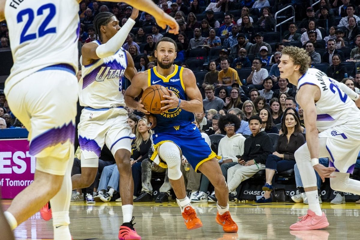 Jan 3, 2026; San Francisco, California, USA;  Golden State Warriors guard Stephen Curry (30) drives past Utah Jazz forward Cody Williams (5) during the second quarter at Chase Center. Mandatory Credit: John Hefti-Imagn Images