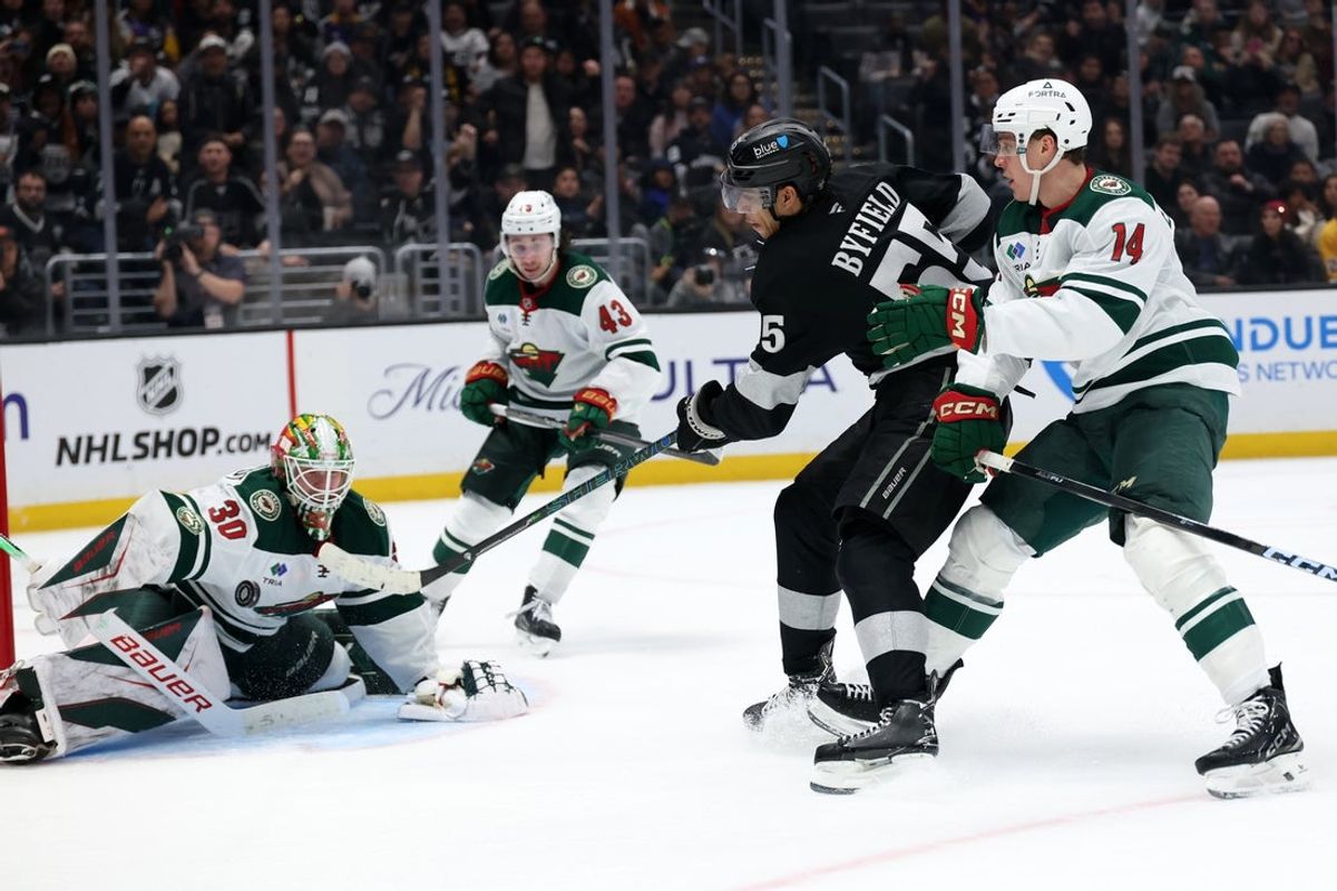 Jan 3, 2026; Los Angeles, California, USA;  Minnesota Wild goaltender Jesper Wallstedt (30) blocks the puck shot by Los Angeles Kings right wing Quinton Byfield (55) during overtime at Crypto.com Arena. Mandatory Credit: Kiyoshi Mio-Imagn Images