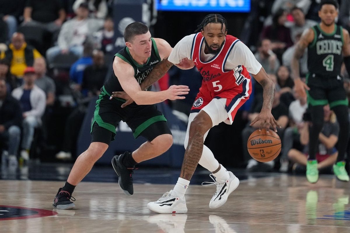 Jan 3, 2026; Inglewood, California, USA; LA Clippers forward Derrick Jones Jr. (5) is defended by Boston Celtics guard Payton Pritchard (11) in the second half at Intuit Dome. Mandatory Credit: Kirby Lee-Imagn Images