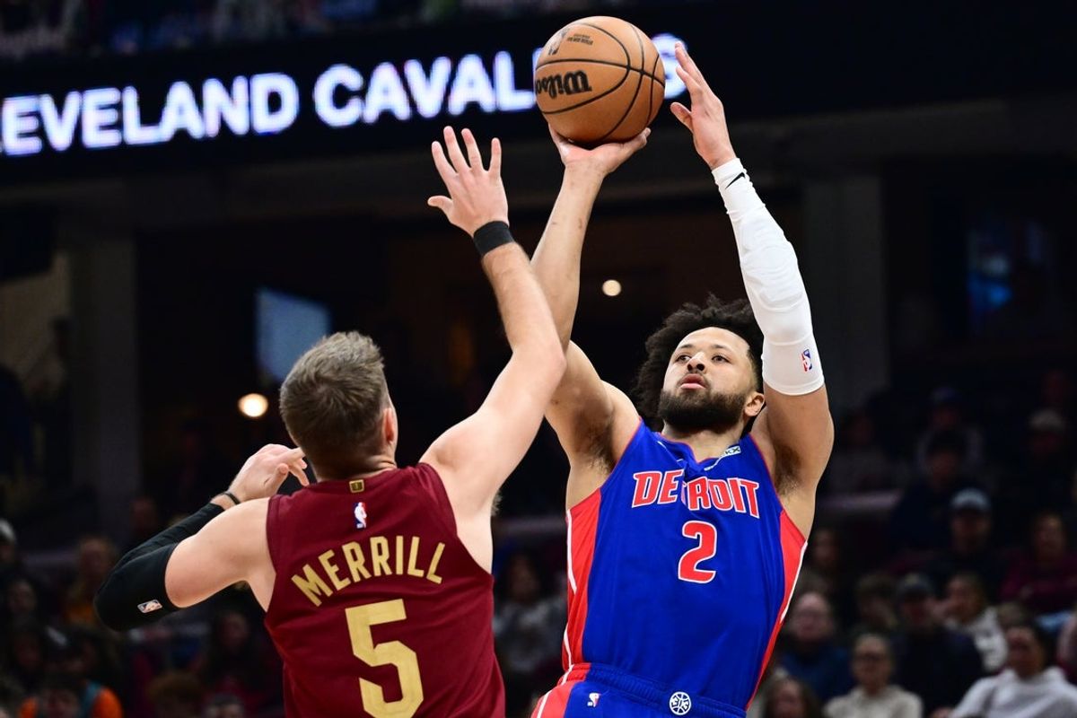 Jan 4, 2026; Cleveland, Ohio, USA; Detroit Pistons guard Cade Cunningham (2) shoots over the defense of  Cleveland Cavaliers guard Sam Merrill (5) during the first half at Rocket Arena. Mandatory Credit: Ken Blaze-Imagn Images
