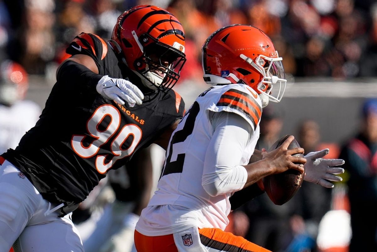 Cincinnati Bengals defensive end Myles Murphy (99) wraps up Cleveland Browns quarterback Shedeur Sanders (12) in the first quarter of the NFL Week 18 game between the Cincinnati Bengals and the Cleveland Browns at Paycor Stadium in Downtown Cincinnati on Sunday, Jan. 4, 2026.