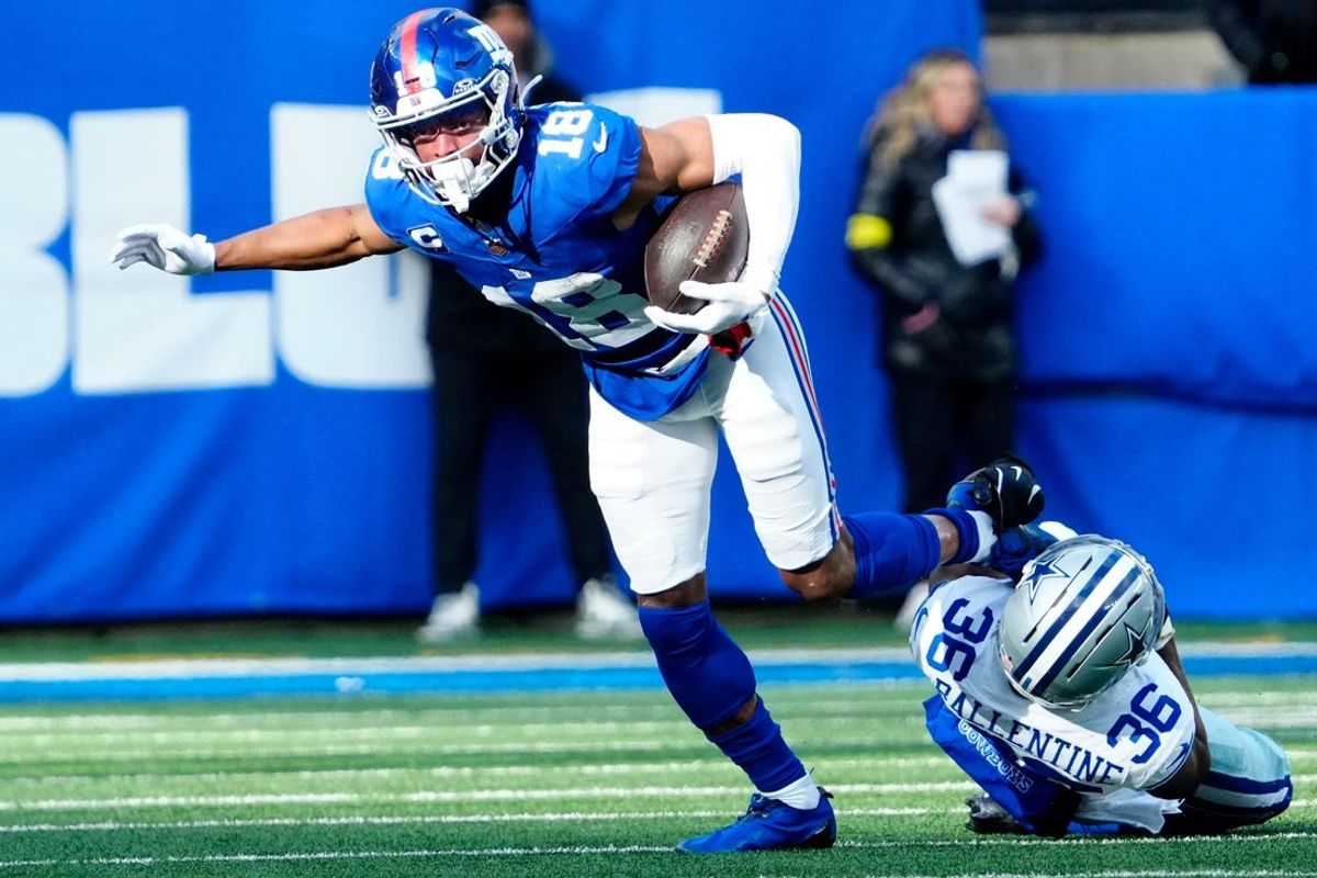 New York Giants wide receiver Darius Slayton (18) breaks a tackle attempt by Dallas Cowboys cornerback Corey Ballentine (36) before getting a Big Blue first down, Sunday, January 4, 2026, in East Rutherford.