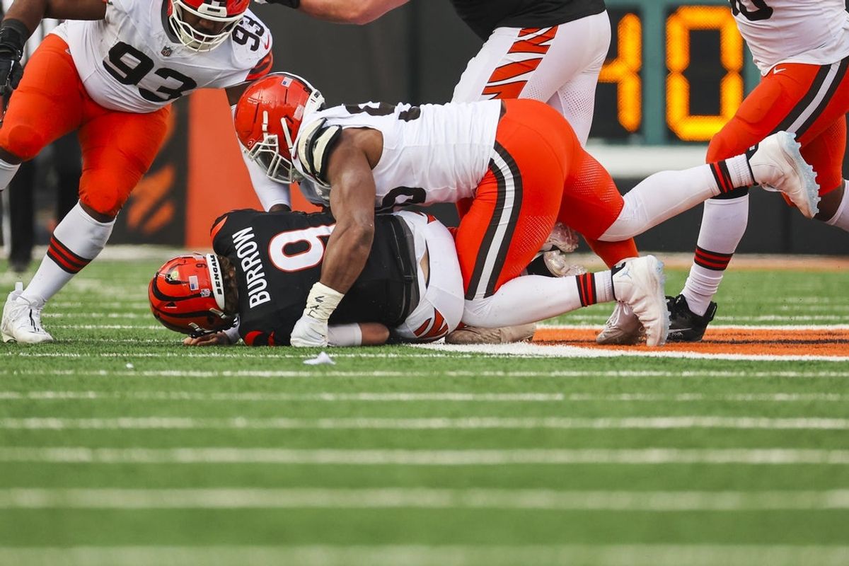 Jan 4, 2026; Cincinnati, Ohio, USA; Cleveland Browns defensive end Myles Garrett (95) sacks Cincinnati Bengals quarterback Joe Burrow (9) during the fourth quarter at Paycor Stadium. The play set a new NFL single season sack record by Garrett. Mandatory Credit: Joseph Maiorana-Imagn Images
