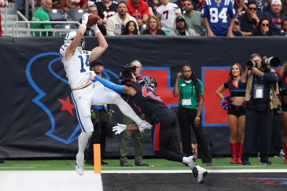 Jan 4, 2026; Houston, Texas, USA;  Indianapolis Colts wide receiver Alec Pierce (14) is pushed out of bounds by Houston Texans cornerback Ja'marcus Ingram (42) during the second half at NRG Stadium. Mandatory Credit: Thomas Shea-Imagn Images