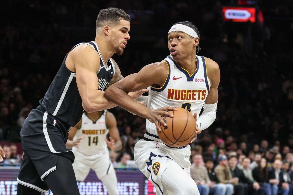 Jan 4, 2026; Brooklyn, New York, USA;  Denver Nuggets guard Peyton Watson (8) looks to drive past Brooklyn Nets forward Michael Porter Jr. (17) in the first quarter at Barclays Center. Mandatory Credit: Wendell Cruz-Imagn Images