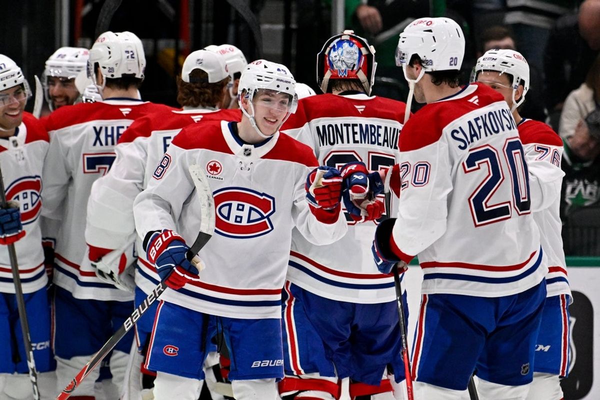 Jan 4, 2026; Dallas, Texas, USA; Montreal Canadiens defenseman Lane Hutson (48) celebrates with left wing Juraj Slafkovsky (20) after Hutson scores the game winning goal against the Dallas Stars during the overtime period at the American Airlines Center. Mandatory Credit: Jerome Miron-Imagn Images