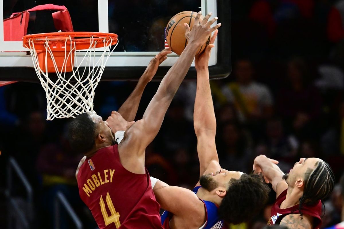 Jan 4, 2026; Cleveland, Ohio, USA; Cleveland Cavaliers center Evan Mobley (4) blocks the shot of Detroit Pistons guard Cade Cunningham (2) during the second half at Rocket Arena. Mandatory Credit: Ken Blaze-Imagn Images