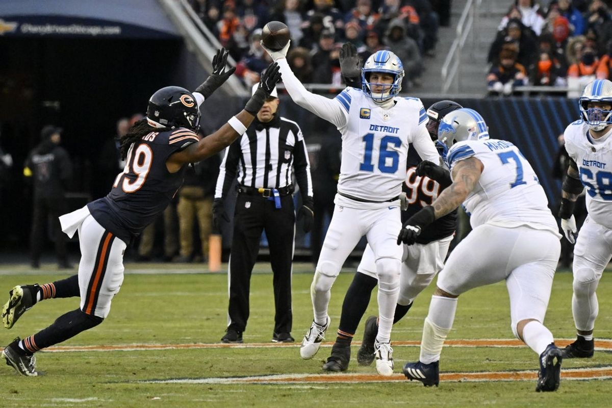 Jan 4, 2026; Chicago, Illinois, USA; Detroit Lions quarterback Jared Goff (16) passes the ball against Chicago Bears linebacker Tremaine Edmunds (49) during the first half at Soldier Field. Mandatory Credit: Matt Marton-Imagn Images