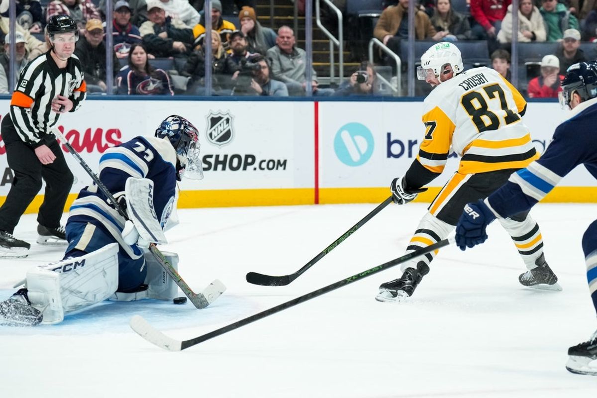 Jan 4, 2026; Columbus, Ohio, USA;  Pittsburgh Penguins center Sidney Crosby (87) scores the game-winning goal against Columbus Blue Jackets goaltender Jet Greaves (73) in the overtime period at Nationwide Arena. Mandatory Credit: Aaron Doster-Imagn Images