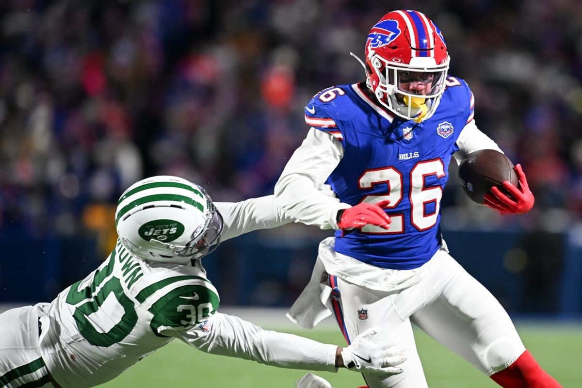 Jan 4, 2026; Orchard Park, New York, USA; Buffalo Bills running back Ty Johnson (26) carries the ball defended by New York Jets cornerback Tre Brown (30) during the third quarter at Highmark Stadium. Mandatory Credit: Mark Konezny-Imagn Images