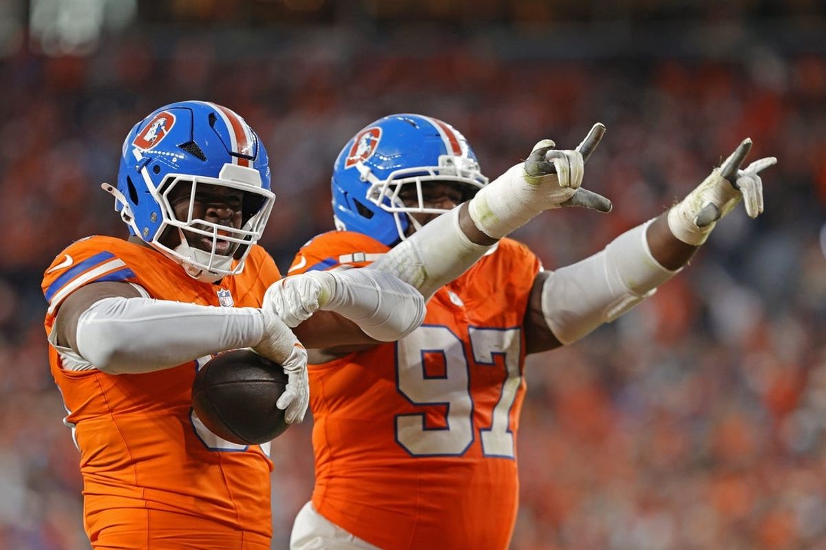 Jan 4, 2026; Denver, Colorado, USA; Denver Broncos defensive defensive end Sai'vion Jones (95) and defensive tackle Malcolm Roach (97) reacts after a fumble recovery during the second half at Empower Field at Mile High. Mandatory Credit: Isaiah J. Downing-Imagn Images