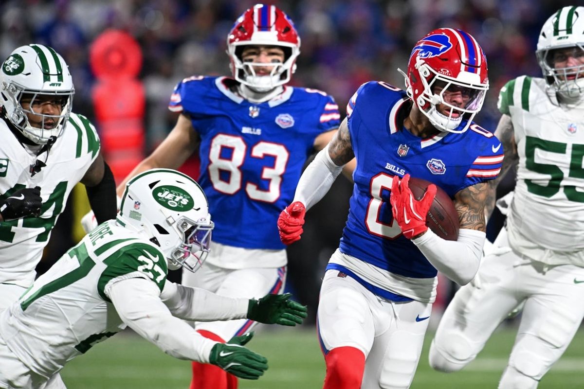 Jan 4, 2026; Orchard Park, New York, USA; Buffalo Bills wide receiver Keon Coleman (0) carries the ball defended by New York Jets safety Malachi Moore (27) during the third quarter at Highmark Stadium. Mandatory Credit: Mark Konezny-Imagn Images