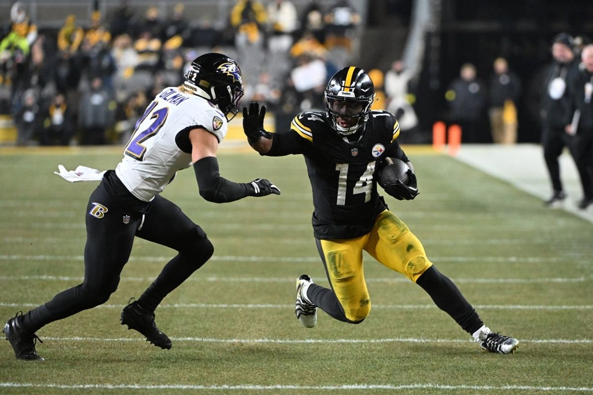 Jan 4, 2026; Pittsburgh, Pennsylvania, USA; Pittsburgh Steelers running back Kenneth Gainwell (14) rushes the ball against Baltimore Ravens safety Alohi Gilman (12) during the first half at Acrisure Stadium. Mandatory Credit: Barry Reeger-Imagn Images