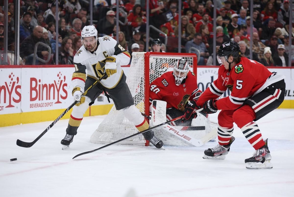 Jan 4, 2026; Chicago, Illinois, USA; Vegas Golden Knights right wing Mark Stone (61) and Chicago Blackhawks defenseman Connor Murphy (5) battle for control of the puck during the second period at United Center. Mandatory Credit: Talia Sprague-Imagn Images