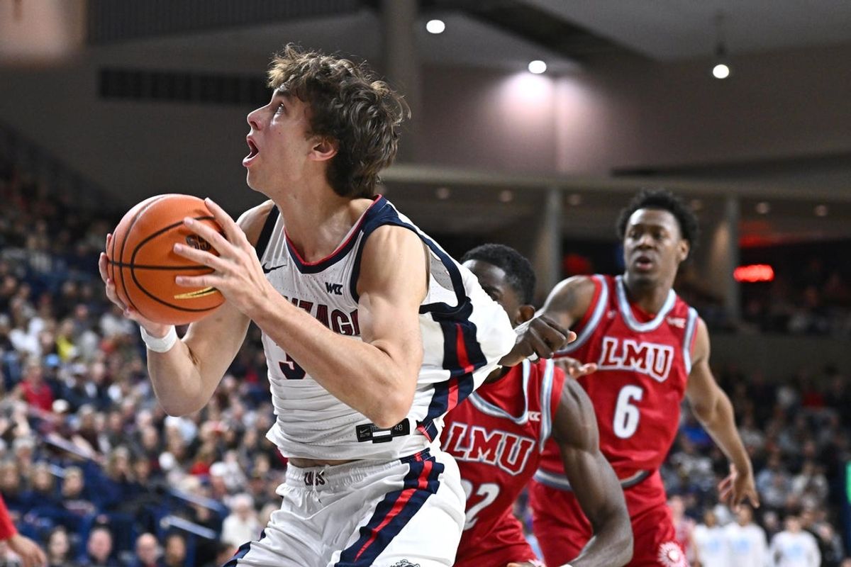 Jan 4, 2026; Spokane, Washington, USA; Gonzaga Bulldogs forward Braden Huff (34) shoots the ball against Loyola Marymount Lions center Rick Issanza (22) in the second half at McCarthey Athletic Center. Mandatory Credit: James Snook-Imagn Images