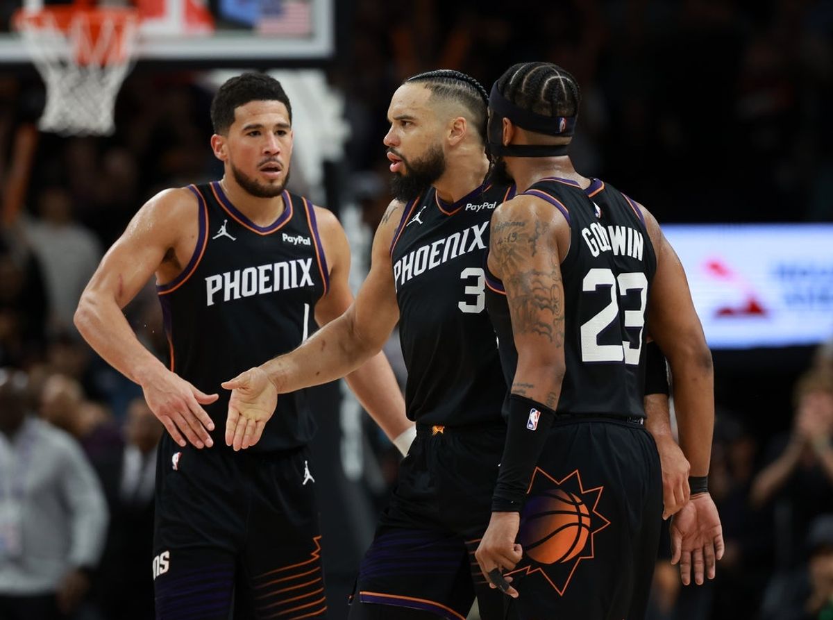 Jan 4, 2026; Phoenix, Arizona, USA; Phoenix Suns forward Dillon Brooks (3) celebrates with teammates Devin Booker (1) and Jordan Goodwin (23) against the Oklahoma City Thunder in the second half at Mortgage Matchup Center. Mandatory Credit: Mark J. Rebilas-Imagn Images