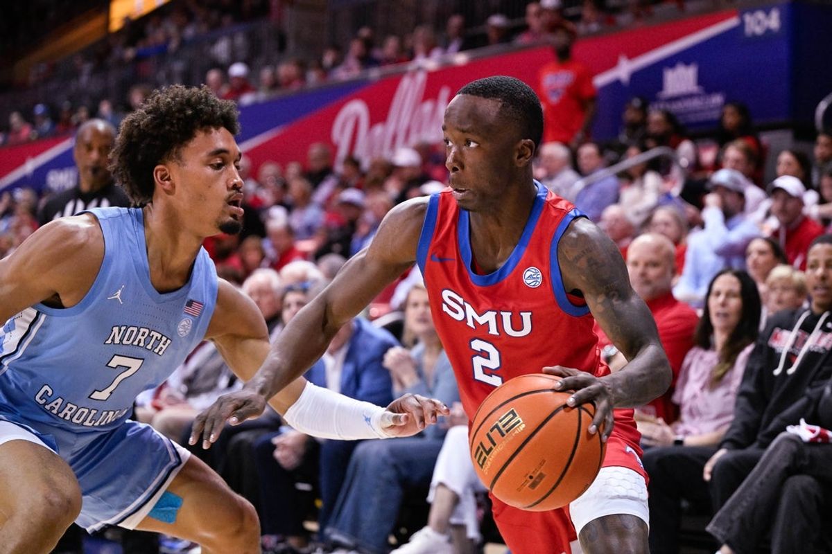 Jan 3, 2026; Dallas, Texas, USA; SMU Mustangs guard Boopie Miller (2) drives to the basket past North Carolina Tar Heels guard Seth Trimble (7) during the game between the Mustangs and the Tar Heels at Moody Coliseum. Mandatory Credit: Jerome Miron-Imagn Images