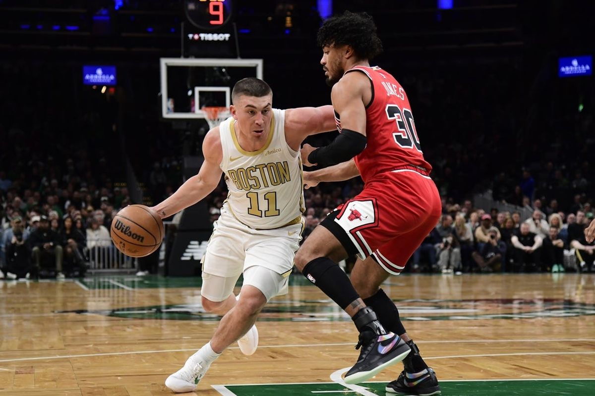 Jan 5, 2026; Boston, Massachusetts, USA;  Boston Celtics guard Payton Pritchard (11) controls the ball while Chicago Bulls guard Tre Jones (30) defends during the first half at TD Garden. Mandatory Credit: Bob DeChiara-Imagn Images