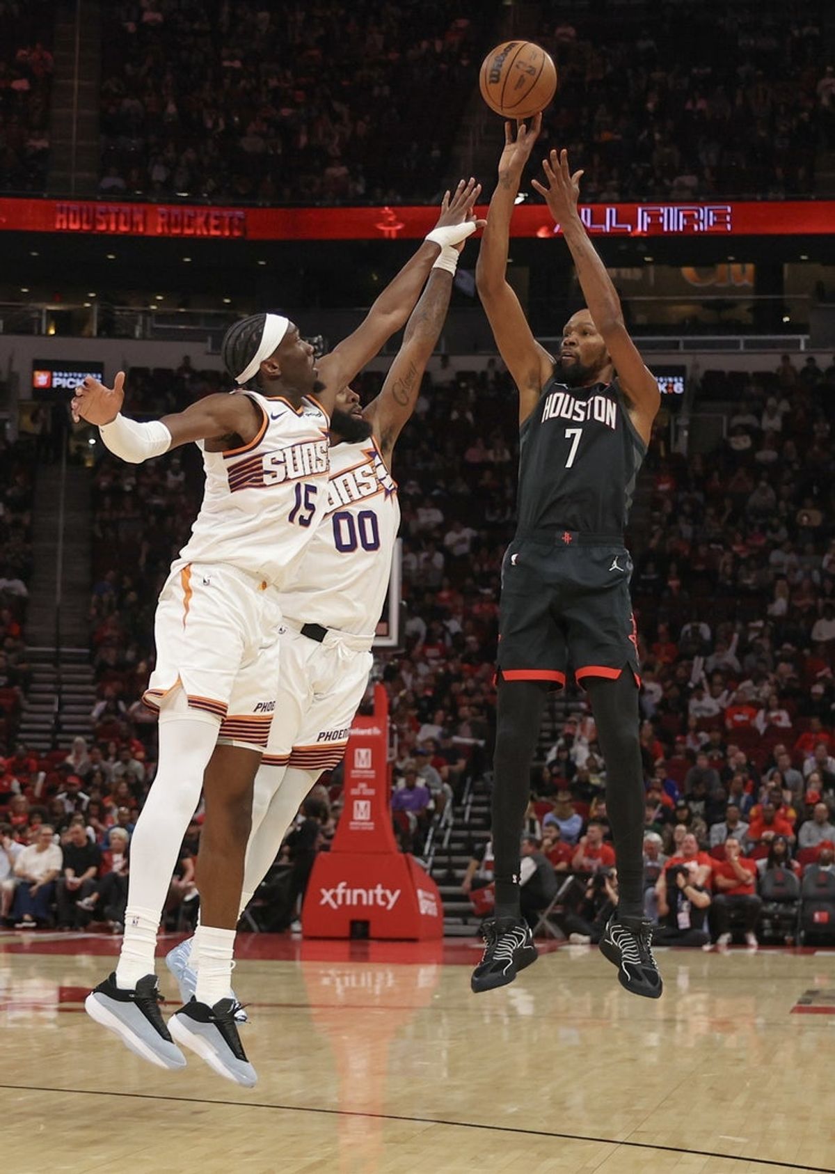 Jan 5, 2026; Houston, Texas, USA; Houston Rockets forward Kevin Durant (7) shoots against Phoenix Suns forward Royce O'Neale (00) and center Mark Williams (15)  in the first quarter at Toyota Center. Mandatory Credit: Thomas Shea-Imagn Images