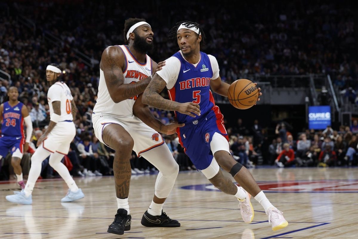 Jan 5, 2026; Detroit, Michigan, USA;  Detroit Pistons forward Ronald Holland II (5) dribbles defended by New York Knicks center Mitchell Robinson (23) in the second half at Little Caesars Arena. Mandatory Credit: Rick Osentoski-Imagn Images