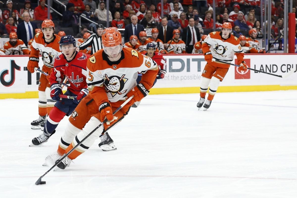 Jan 5, 2026; Washington, District of Columbia, USA; Anaheim Ducks defenseman Jacob Trouba (65) skates with the puck past Washington Capitals left wing Anthony Beauvillier (72) during the third period at Capital One Arena. Mandatory Credit: Geoff Burke-Imagn Images