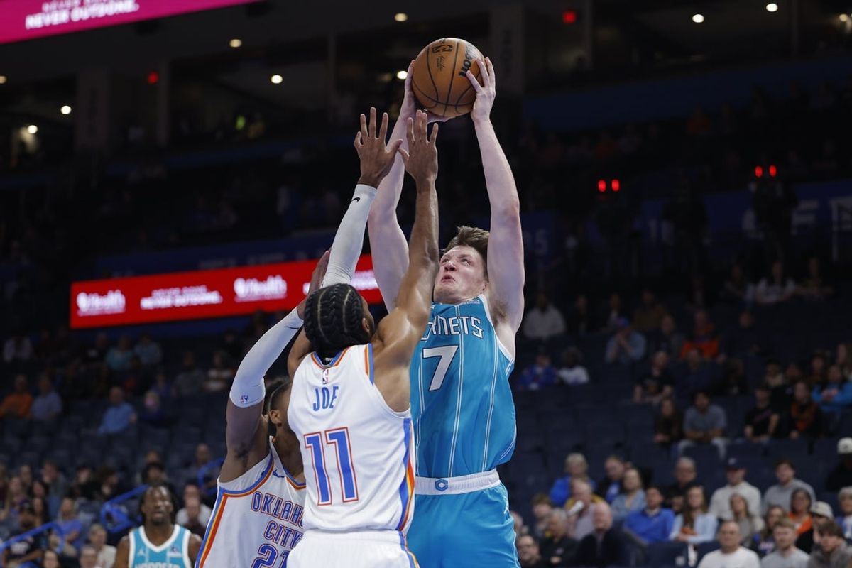 Jan 5, 2026; Oklahoma City, Oklahoma, USA; Charlotte Hornets guard Kon Knueppel (7) goes up for a basket over Oklahoma City Thunder guard Isaiah Joe (11) during the second half at Paycom Center. Mandatory Credit: Alonzo Adams-Imagn Images