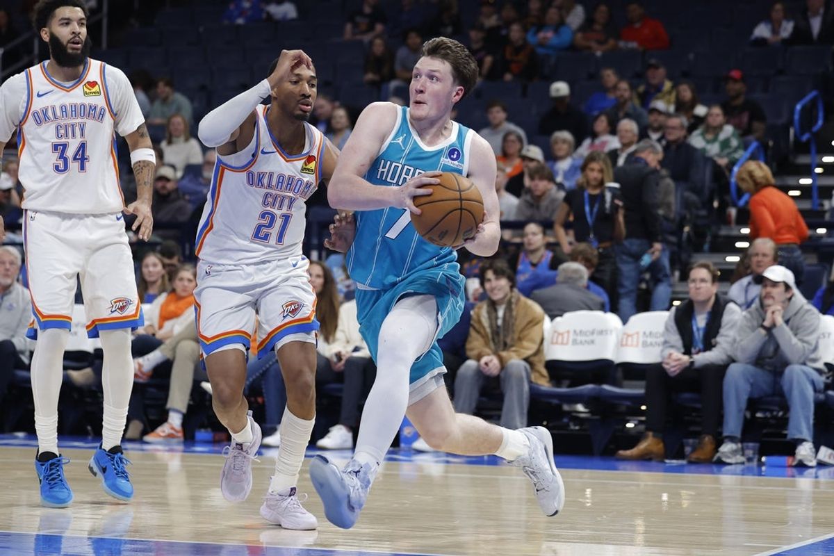 Jan 5, 2026; Oklahoma City, Oklahoma, USA; Charlotte Hornets guard Kon Knueppel (7) drives to the basket past Oklahoma City Thunder guard Aaron Wiggins (21) during the second half at Paycom Center. Mandatory Credit: Alonzo Adams-Imagn Images