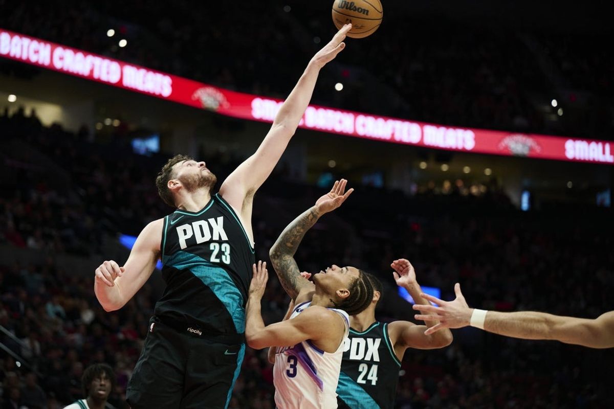 Jan 5, 2026; Portland, Oregon, USA; Portland Trail Blazers center Donovan Clingan (23) blocks a shot during the first half against Utah Jazz guard Keyonte George (3) at Moda Center. Mandatory Credit: Troy Wayrynen-Imagn Images