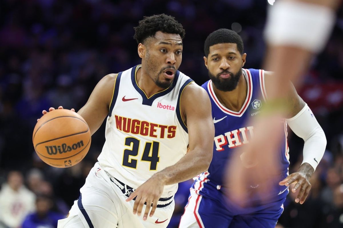 Jan 5, 2026; Philadelphia, Pennsylvania, USA; Denver Nuggets guard Jalen Pickett (24) drives past Philadelphia 76ers forward Paul George (8) during the fourth quarter at Xfinity Mobile Arena. Mandatory Credit: Bill Streicher-Imagn Images