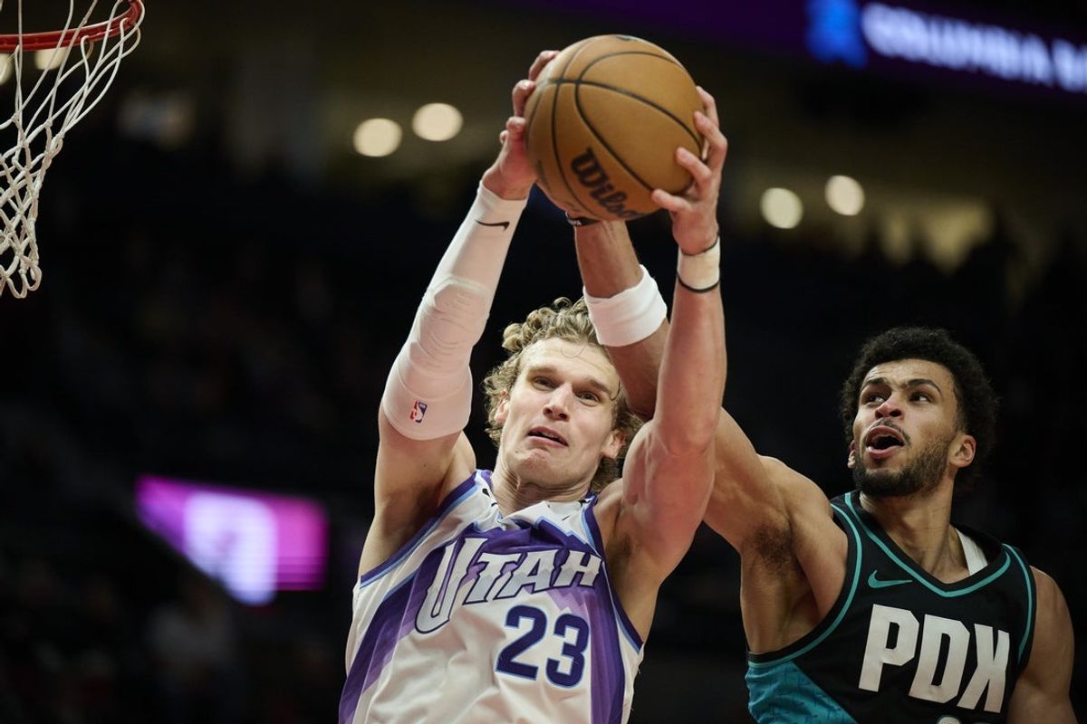 Jan 5, 2026; Portland, Oregon, USA; Utah Jazz forward Lauri Markkanen (23) rebounds the ball during the second half against Portland Trail Blazers forward Toumani Camara (33) at Moda Center. Mandatory Credit: Troy Wayrynen-Imagn Images