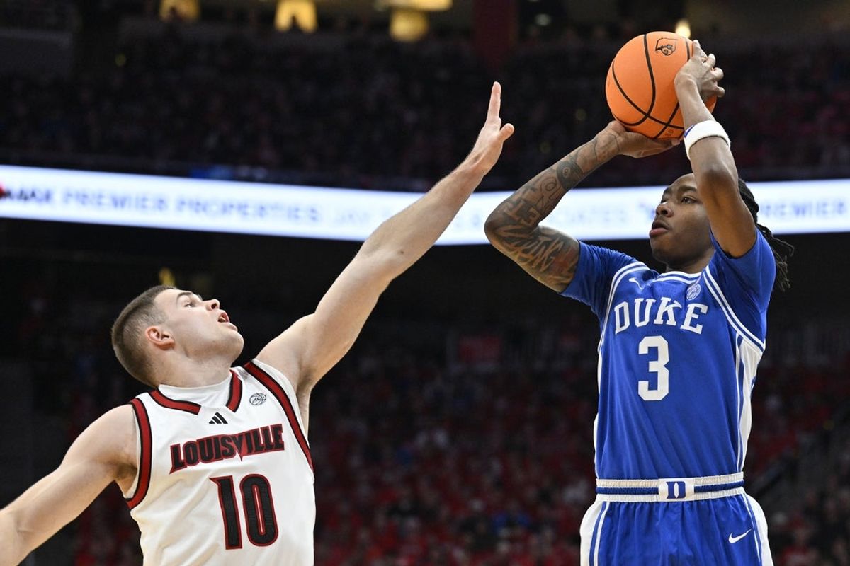Jan 6, 2026; Louisville, Kentucky, USA;  Duke Blue Devils guard Isaiah Evans (3) shoots against Louisville Cardinals guard Isaac McKneely (10) during the first half at KFC Yum! Center. Mandatory Credit: Jamie Rhodes-Imagn Images